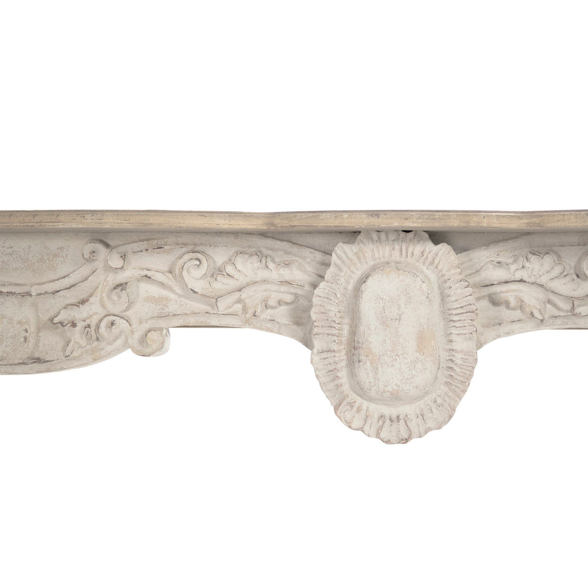 Close-up of the Abraham console's carved rococo apron and cartouche in distressed cream