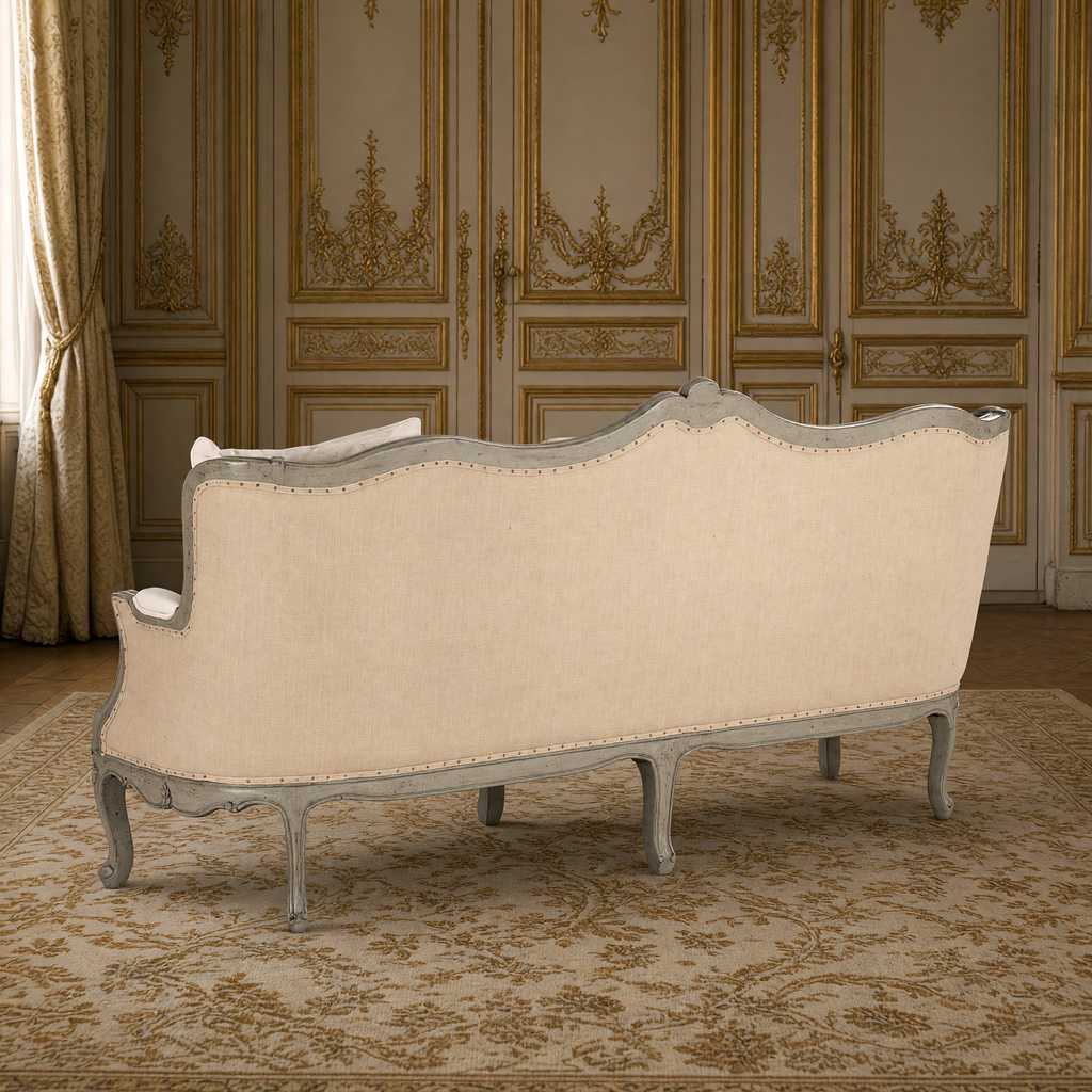 Back view of the Adele Carved French Cotton Sofa with Burlap Back showing the natural burlap outside back with nailhead trim