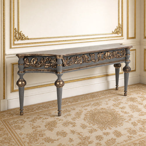 Adrian Neoclassical Carved Birch Console in grey-blue and antique gilt against a gilded Louis XVI boiserie wall on an Aubusson carpet