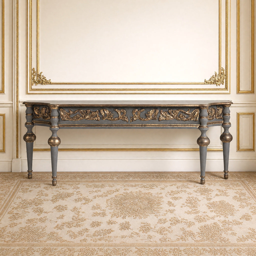 Front view of the Adrian Neoclassical Carved Birch Console against a gilded boiserie wall