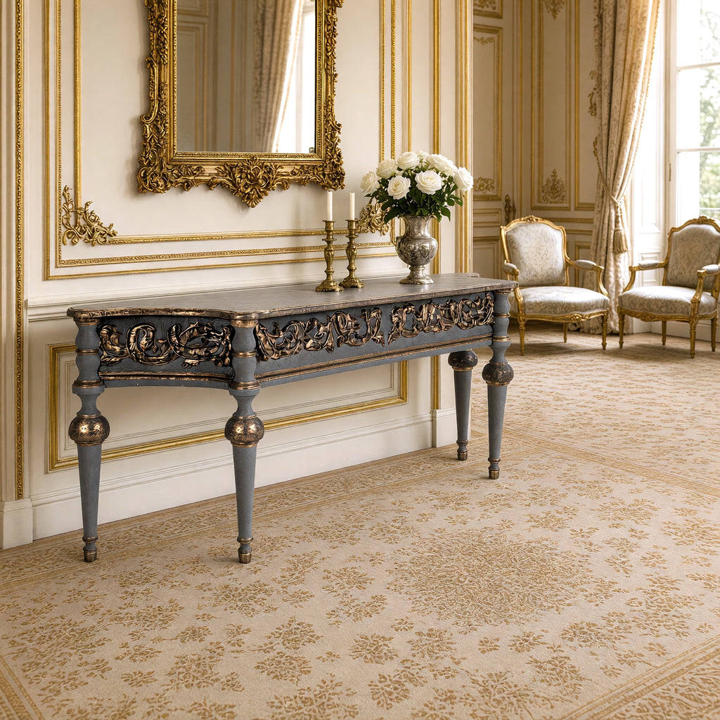 Adrian Neoclassical Carved Birch Console styled beneath a gilded mirror with candlesticks and white roses in a French salon