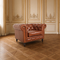 Arthur Chesterfield leather arm chair in cognac brown in a classical ivory and gold French salon