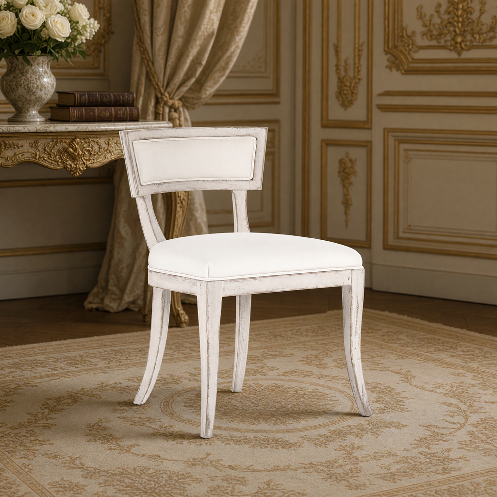 Closer view of the curved back rail and sabre legs of the Ayer Klismos Carved Wood Side Chair in Off-White Cotton, Birch