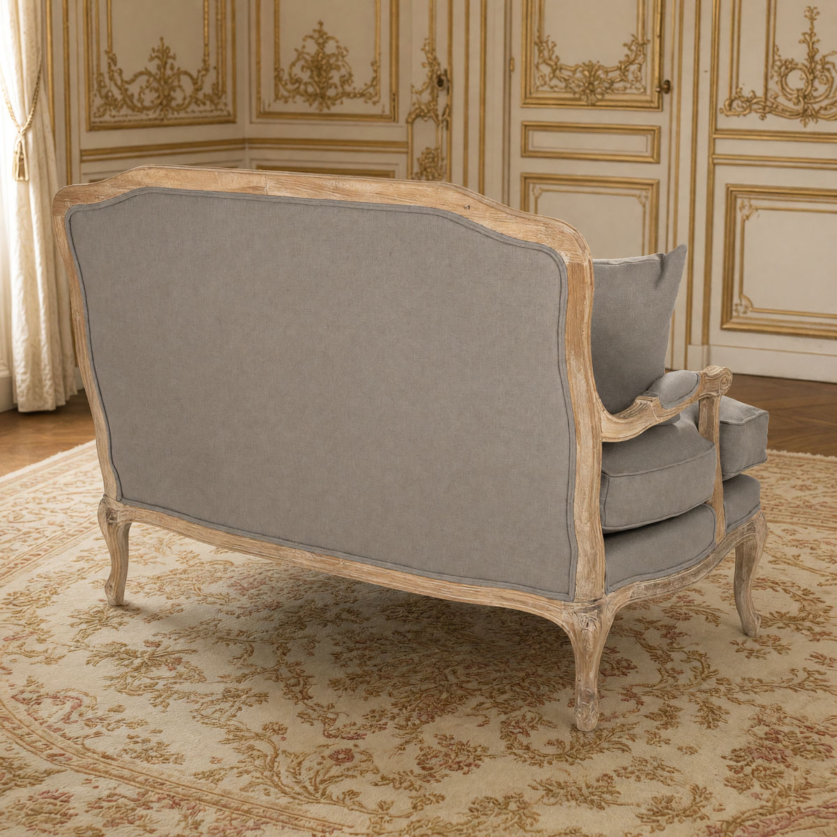 Back view of the Bastille settee showing the linen back and carved oak frame