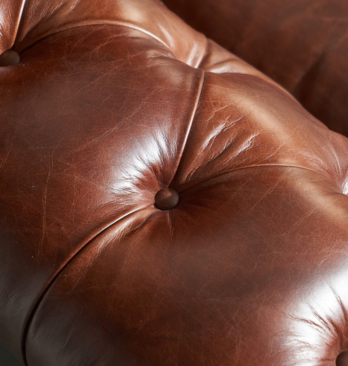 Close-up of the button-tufted vintage leather of the Bromley Chesterfield Leather Sofa