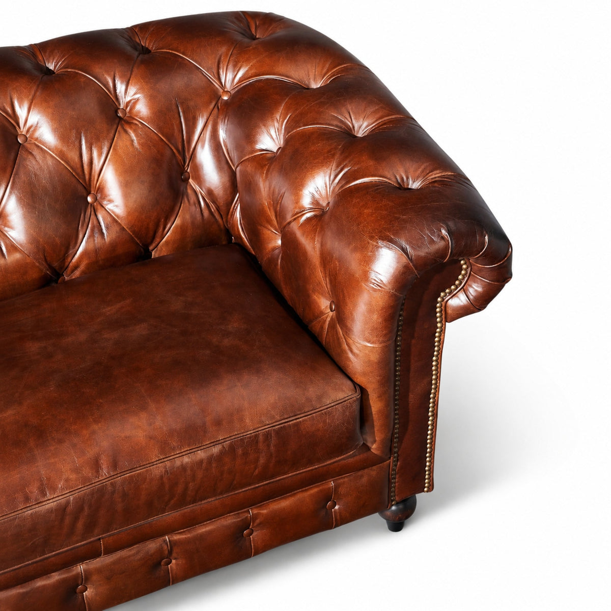 Close-up of the Bromley sofa's tufted back, rolled arm and vintage brown leather