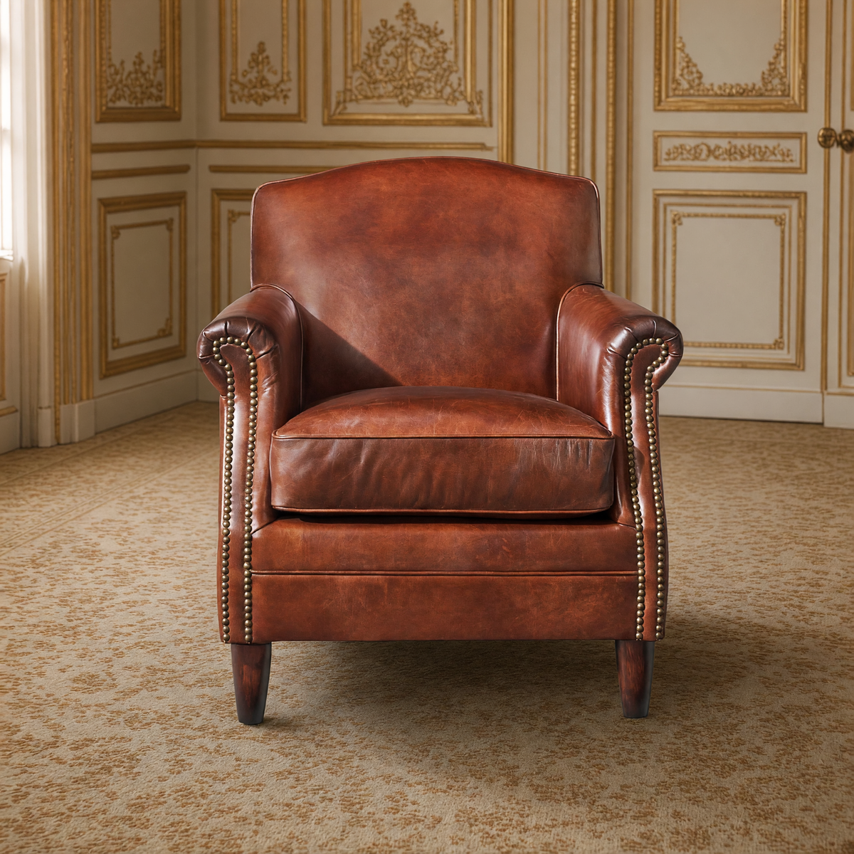 Front view of the Bromwell club chair with brass nailheads on its rolled arms