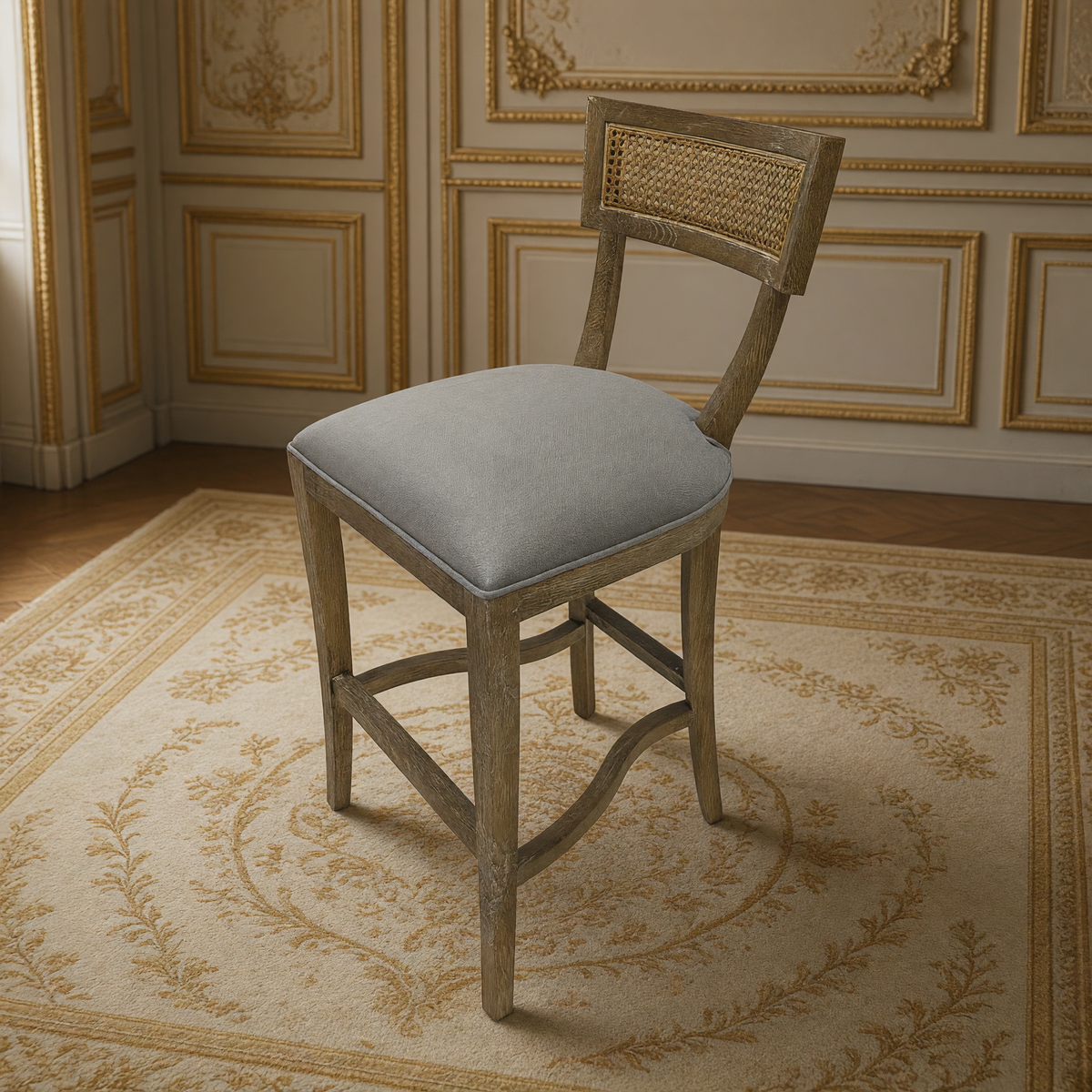 Carvell Cane Back Oak Bar Stool in Grey Linen, three-quarter view in a French salon on an antique Aubusson carpet
