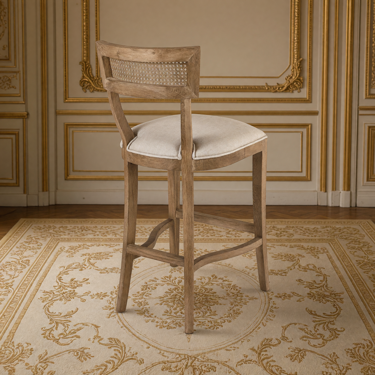 Carvell Cane Back Oak Bar Stool in Natural Linen, Solid Oak, rear three-quarter view showing the cane back, in a French salon