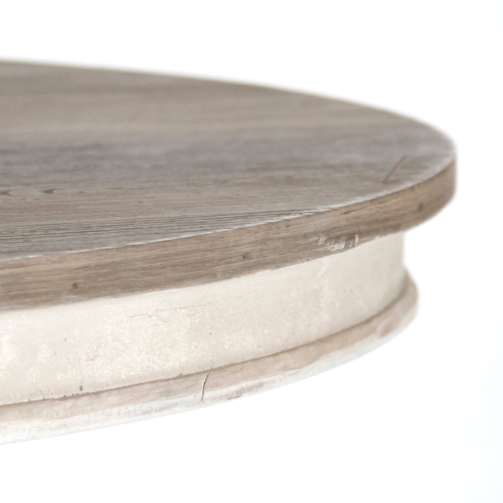 Close-up of the Chandler table's weathered grey elm top over the cream base