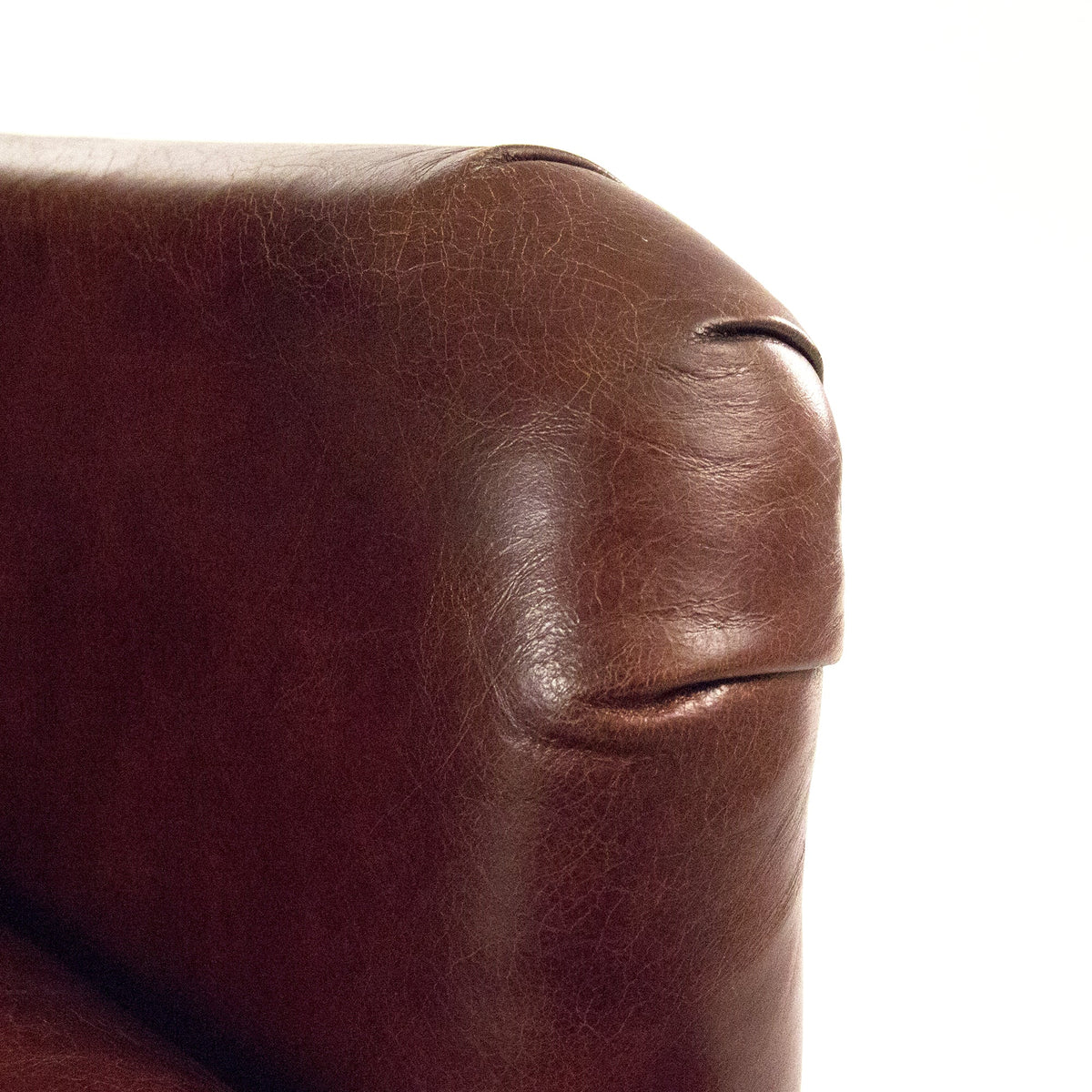 Close-up of the top-grain leather arm of the Felicie Classic Top-Grain Leather Wingback Chair