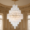 Glacier Drop chandelier glowing beneath a gilded ceiling in a Louis XVI salon