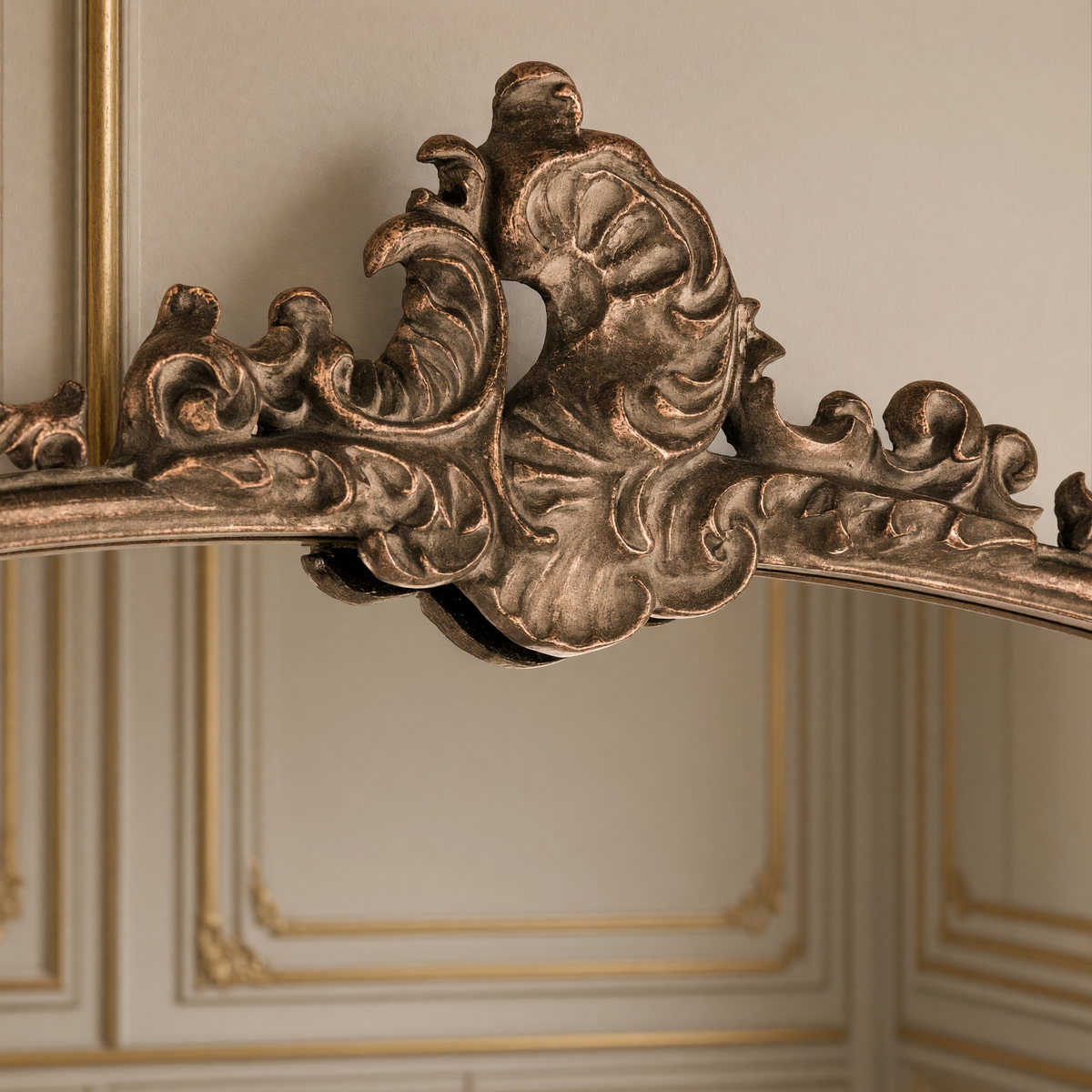 Detail of the ornate metal crest of the Godric French gilded metal arch floor mirror
