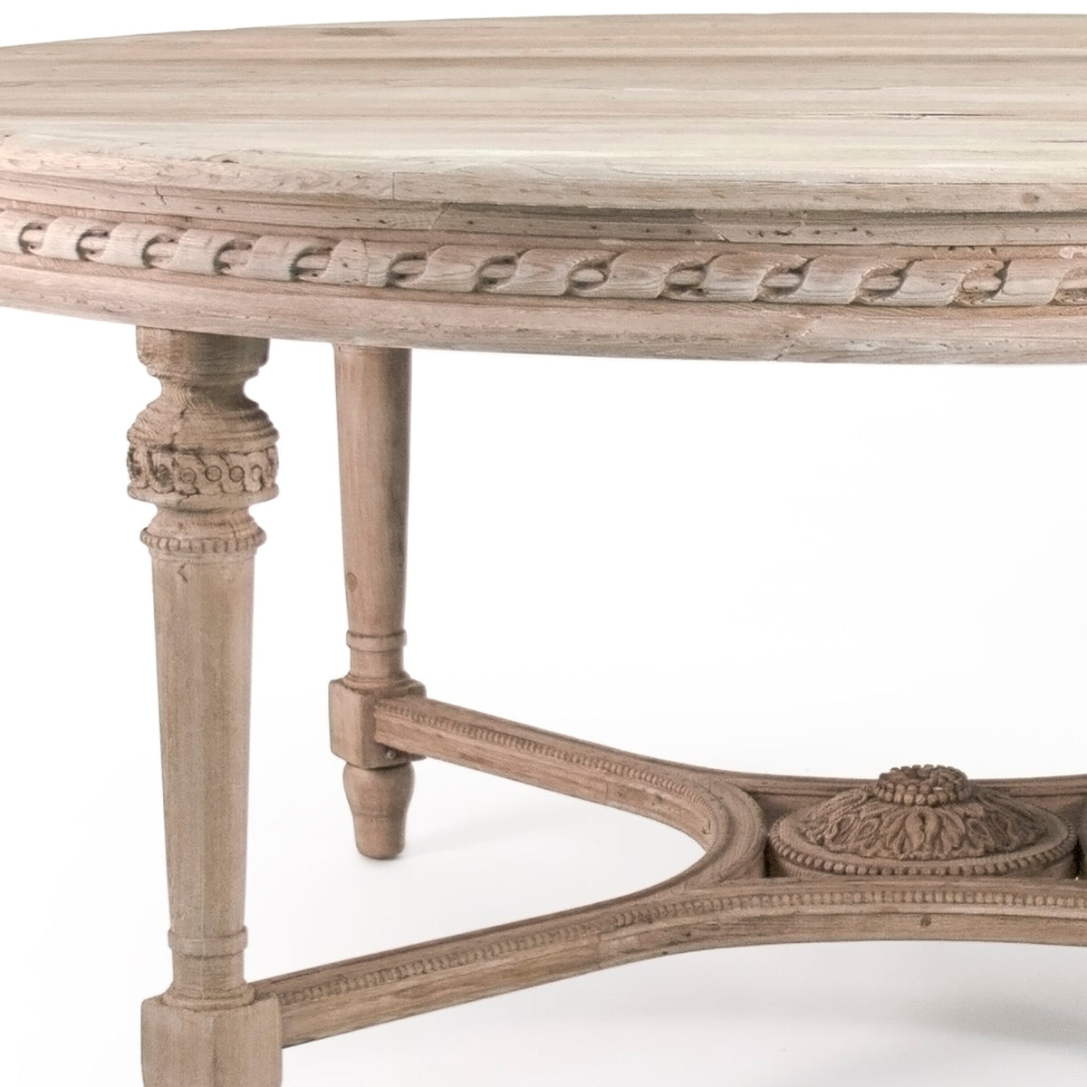 Close-up of the Houston table's carved apron and fluted leg in natural elm