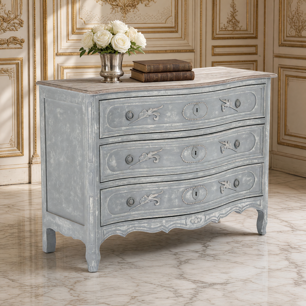 Close view of the carved leaf and medallion drawer fronts of the Lennon French Carved Serpentine Chest in Distressed Grey