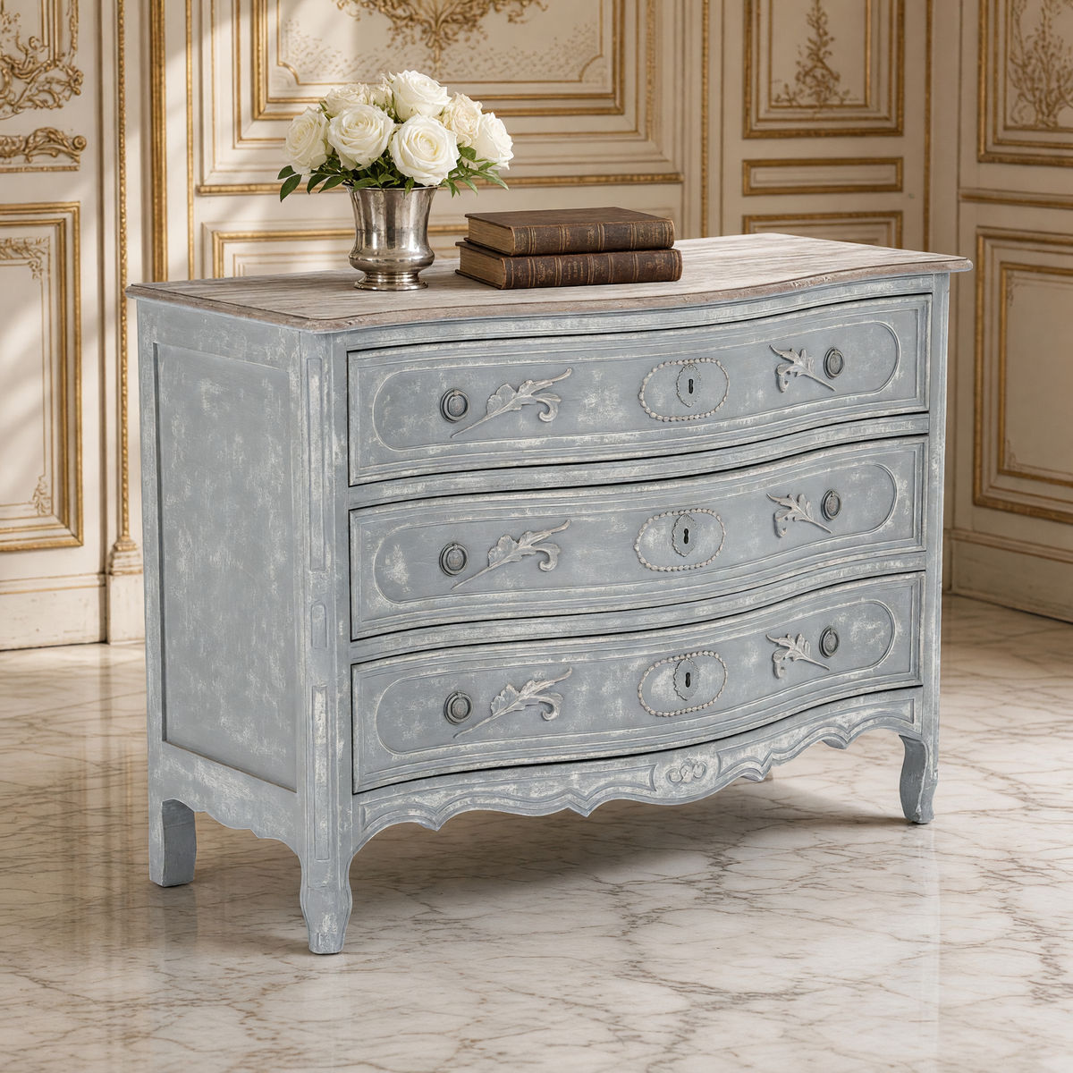 Close view of the carved leaf and medallion drawer fronts of the Lennon French Carved Serpentine Chest in Distressed Grey