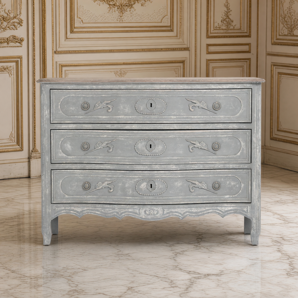 Front view of the Lennon French Carved Serpentine Chest in Distressed Grey in a French boiserie salon