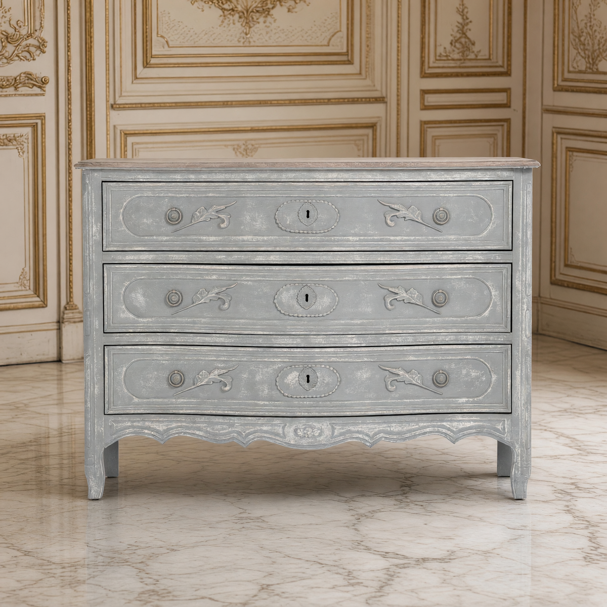 Front view of the Lennon French Carved Serpentine Chest in Distressed Grey in a French boiserie salon
