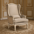 Leon French Linen Wingback Chair in Distressed Ivory Pine on an antique Aubusson carpet in a gilded Louis XVI salon
