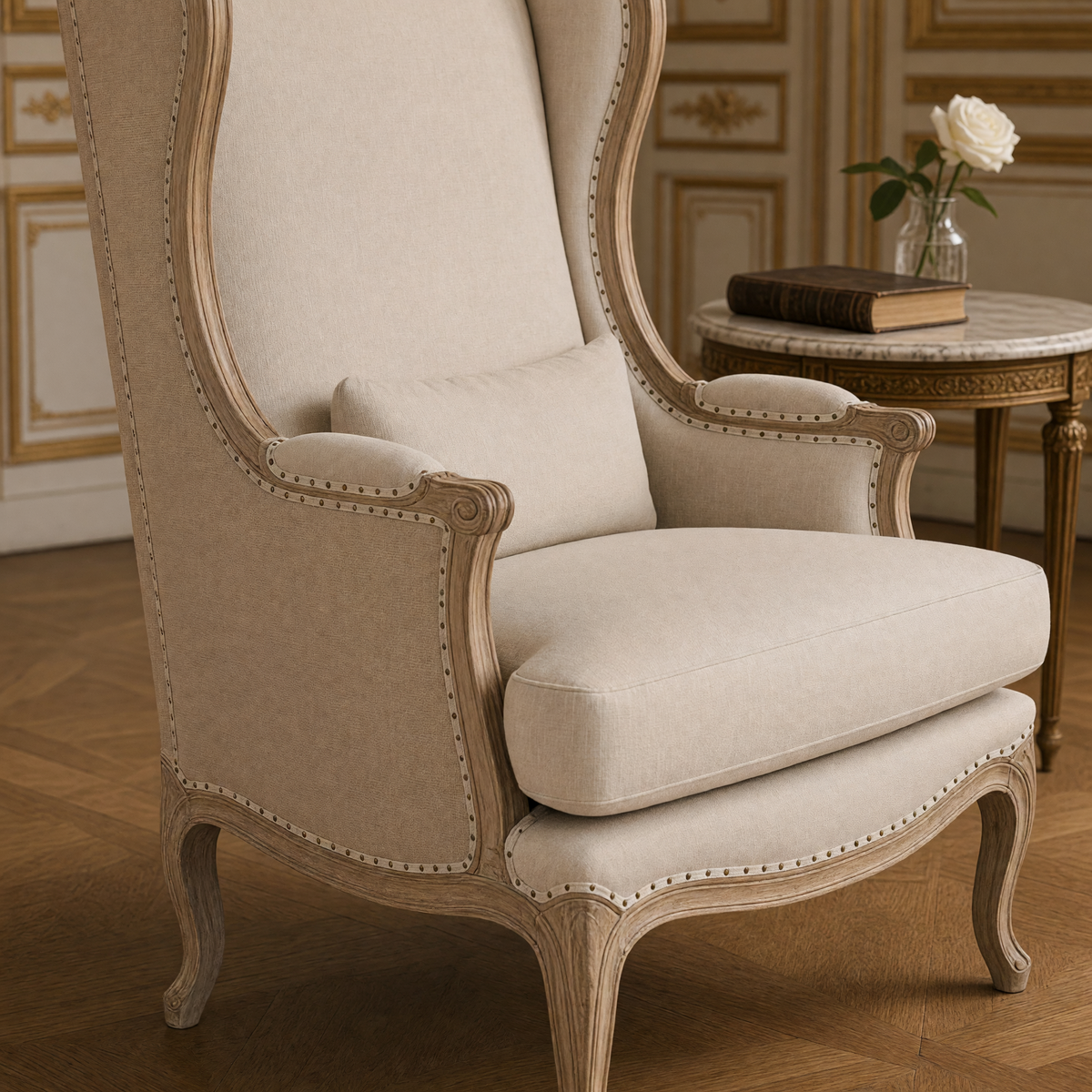 Close-up of the scrolled oak arm, nailhead trim and natural linen cushions of the Leon French Linen Wingback Chair in Natural Oak
