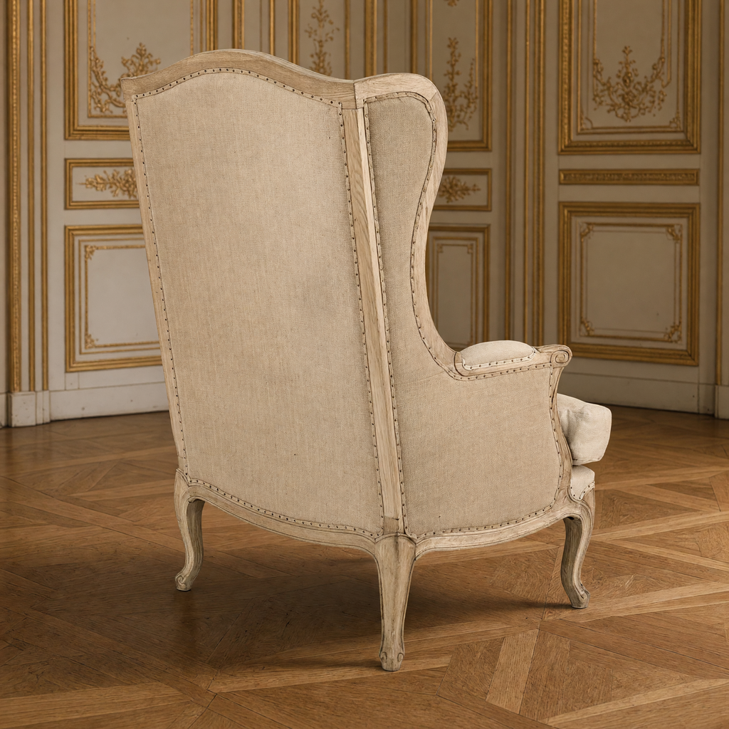 Leon French Linen Wingback Chair in Natural Oak, front three-quarter view in a gilded Louis XVI salon