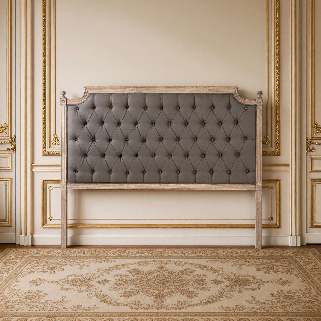 Louis queen tufted headboard in aubergine linen on limed grey oak against a French boiserie wall over an antique Aubusson carpet
