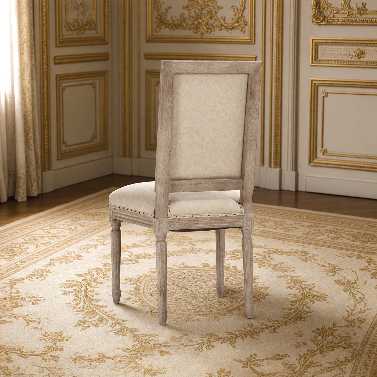 Rear three-quarter view of the Louis square-back side chair in hemp with nailhead trim on limed grey oak