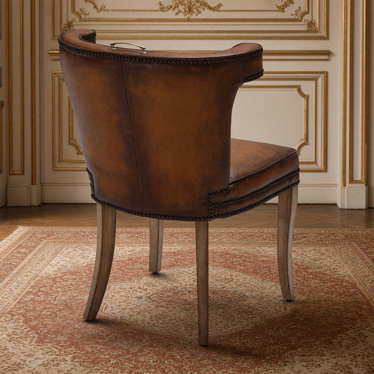 Luca Curved-Back Top-Grain Leather Side Chair in Classic Brown, Solid Wood, rear view showing the leather back and crest pull, in a French salon