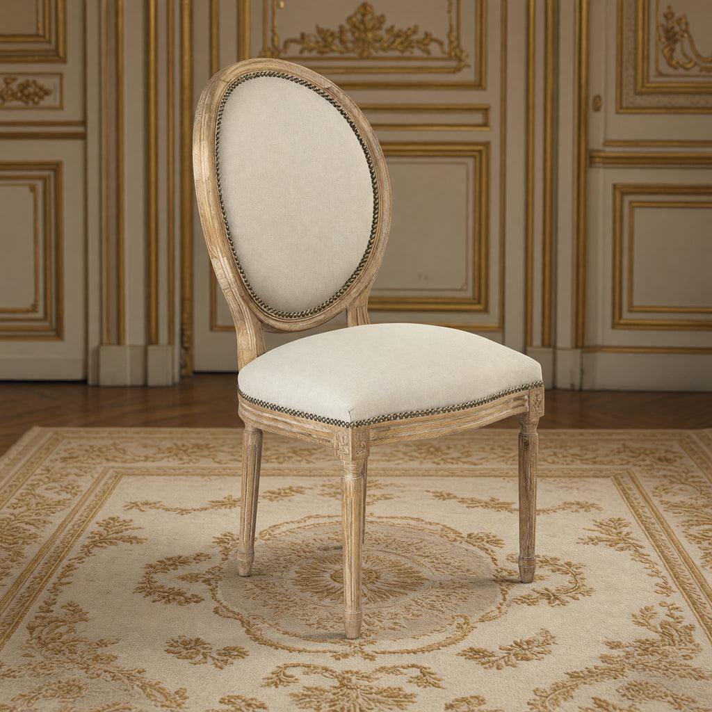 Medallion French oval-back side chair in natural linen with nailhead, limed grey oak in a gilded Louis XVI salon on an Aubusson carpet