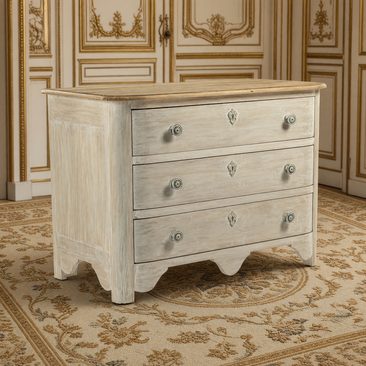 Patric French Painted Elm Chest in Whitewash with Natural Top on an antique Aubusson carpet in an ivory and gold French boiserie salon