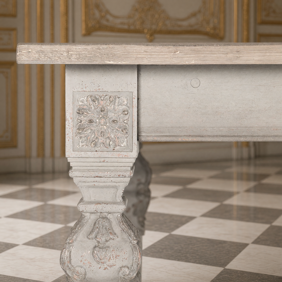 Detail of the carved rosette block and baluster leg of the San Francisco Carved Dining Table in Natural Weathered Wood