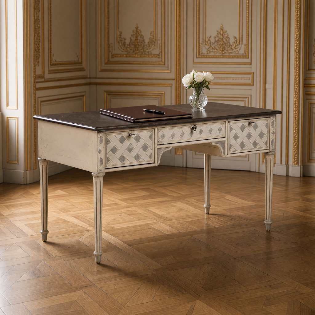 Close view of the trellis-painted drawers and dark top of the Sergei French Painted Writing Desk in Ivory