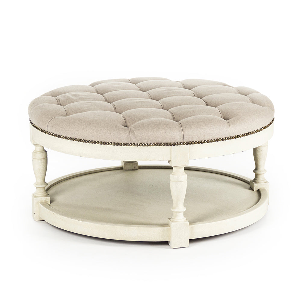 Tammy round ottoman in Distressed Ivory, studio photo 1 of 1 on a white background