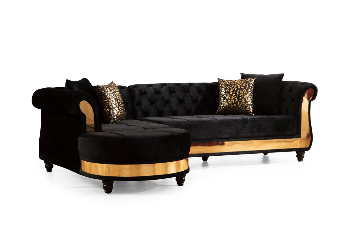 Tufted velvet L-shaped sectional in black, angled view of the chaise end and rolled arm