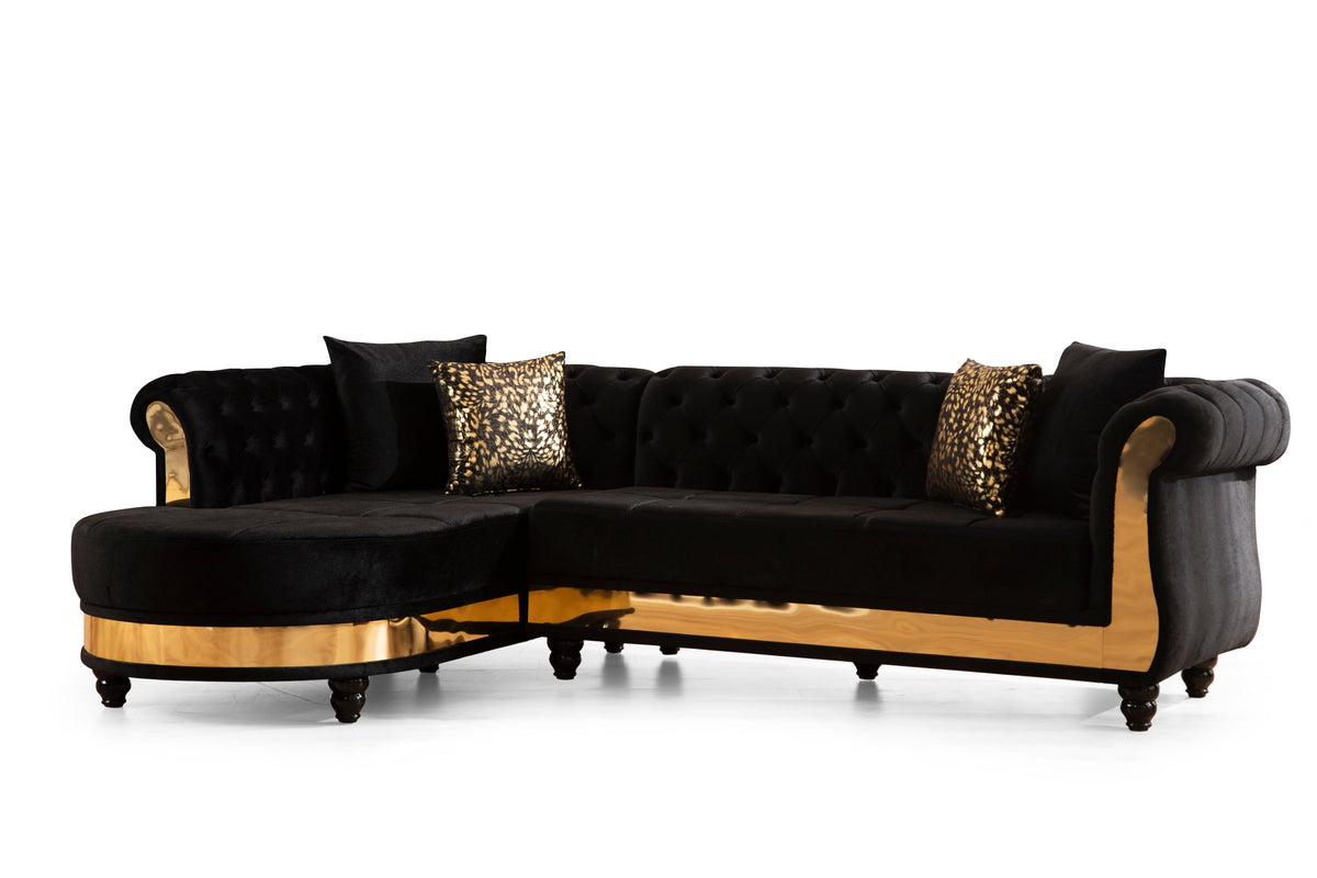 Tufted velvet L-shaped sectional in black with gold trim, three-quarter view on white background