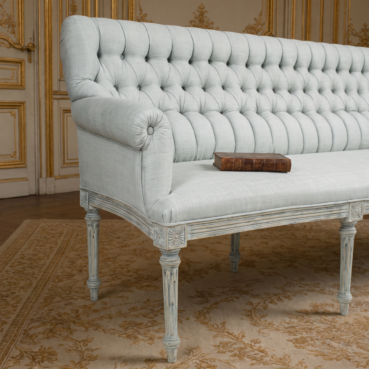 Close-up of the rolled arm, button tufting and carved apron of the Wendy French Tufted Raw Silk Settee